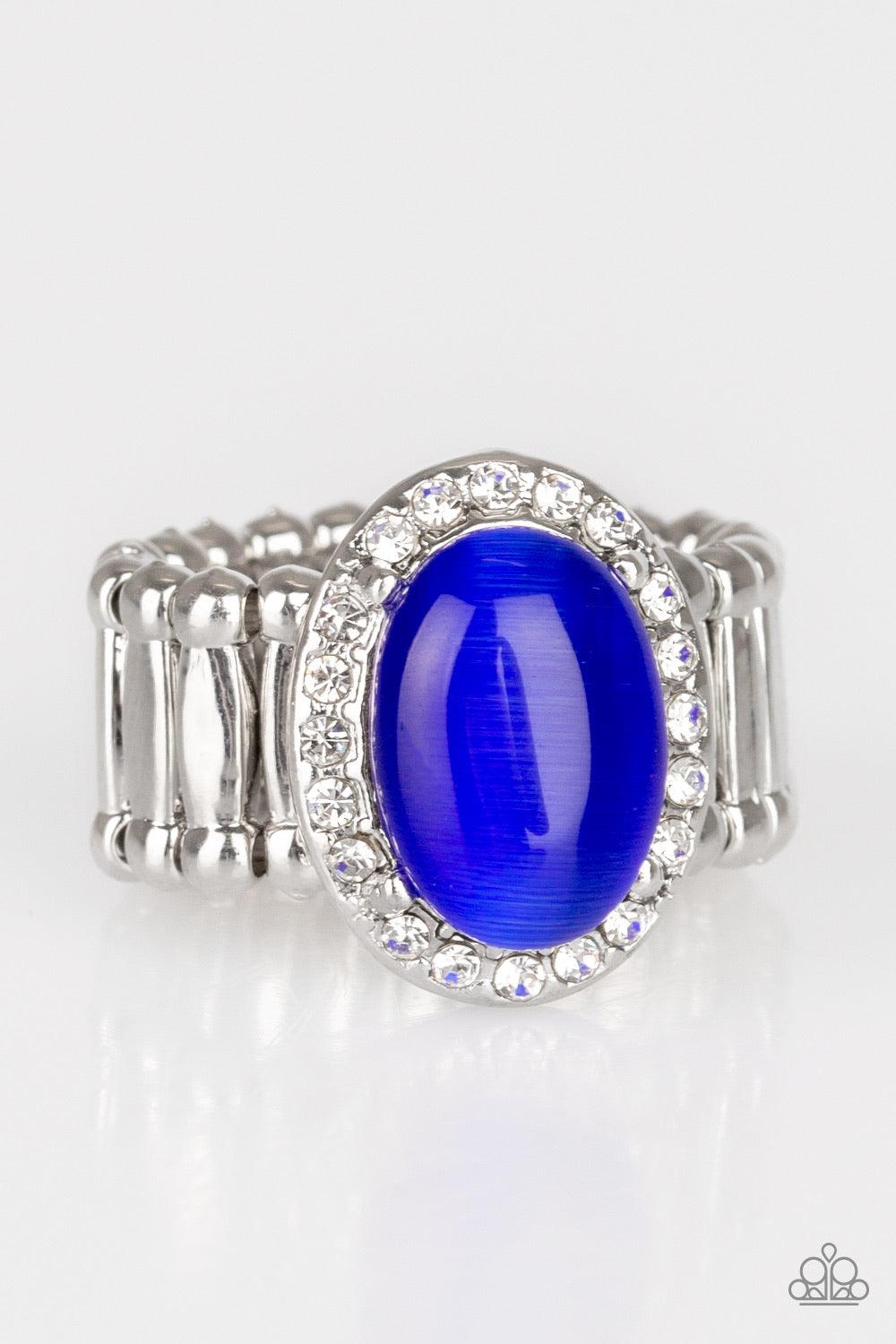 Paparazzi Accessories Laguna Luxury - Blue A majestic Princess Blue moonstone is pressed into the center of a silver frame radiating in glassy white rhinestones for timeless finish. Features a stretchy band for a flexible fit. Jewelry