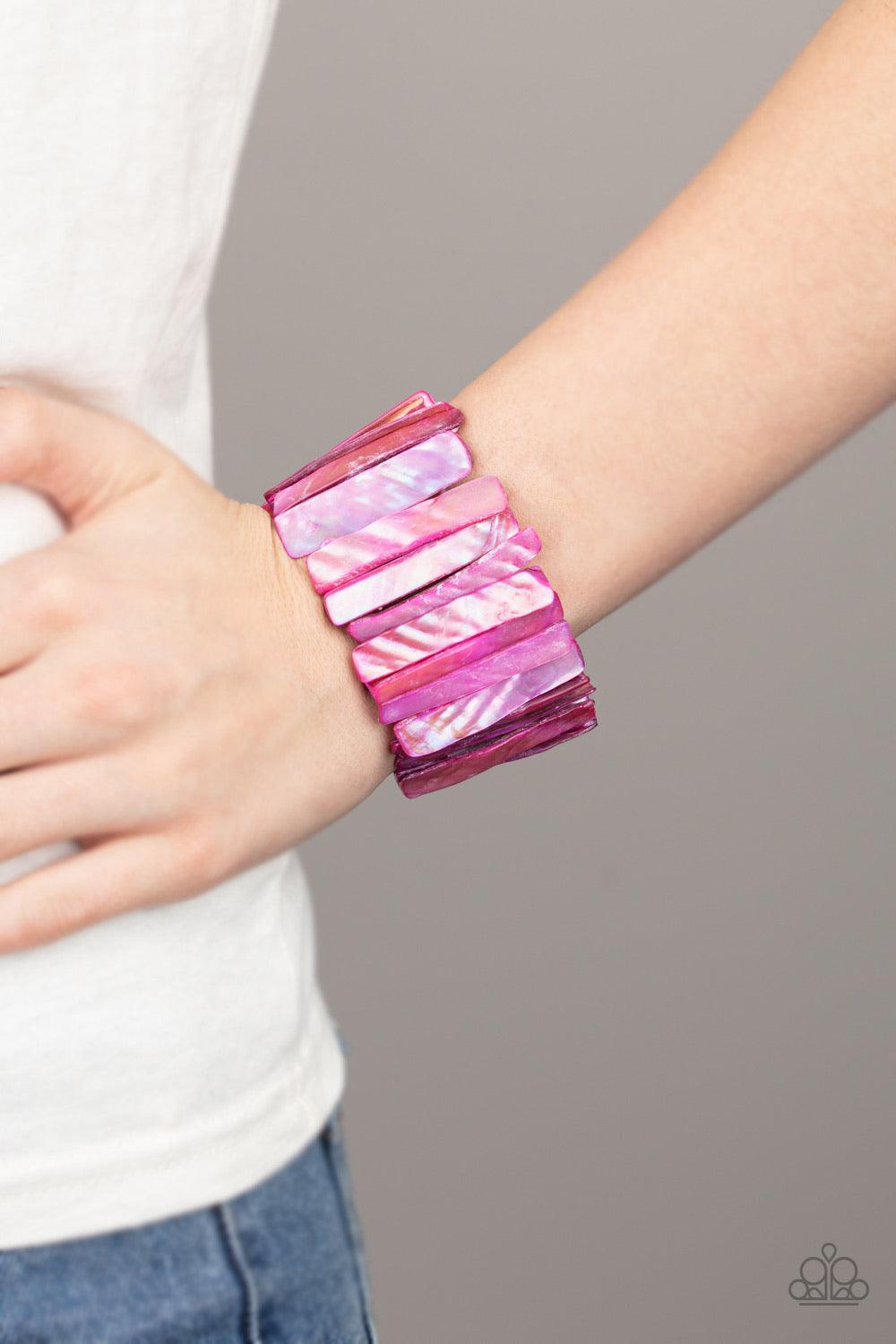 Paparazzi Accessories Beach Blast - Pink Brushed in an iridescent shimmer, pink shell-like pieces are threaded along stretchy bands around the wrist for a colorful beach look. Sold as one individual bracel Jewelry