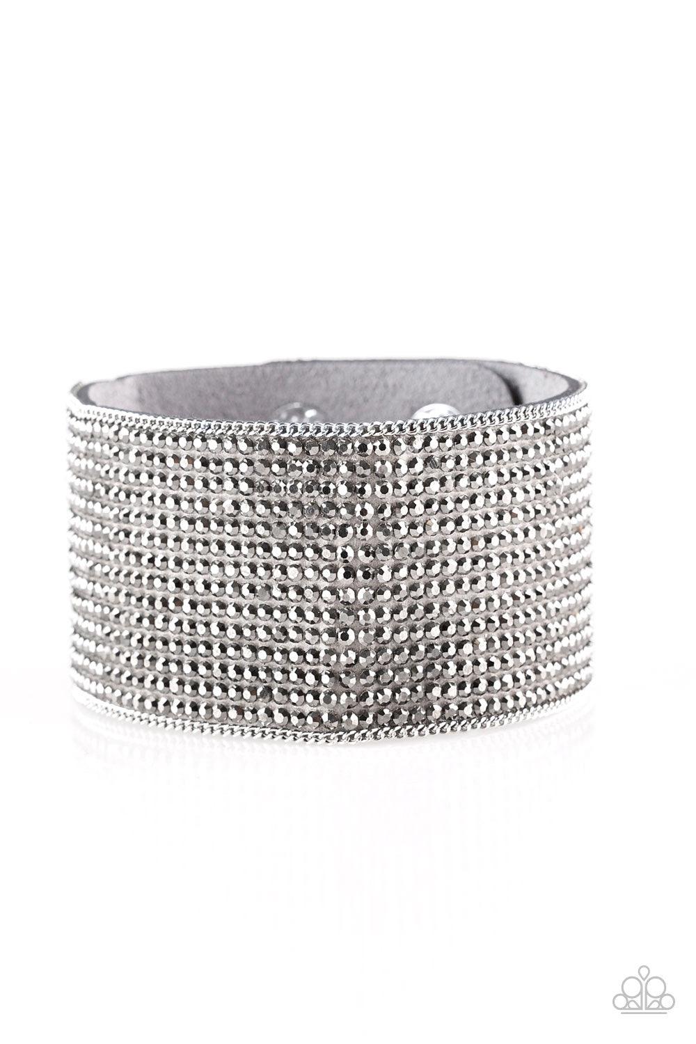 Paparazzi Accessories Glitter Gossip - Silver Row after row of glittery hematite rhinestones are encrusted along a thick gray suede band, creating blinding shimmer across the wrist. Features an adjustable snap closure. Jewelry