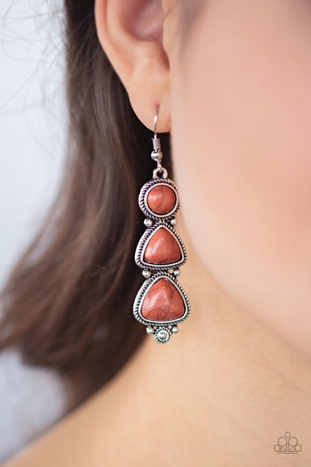 Paparazzi Accessories New Frontier - Brown Chiseled into round and triangular shapes, a trio of brown stone beads stack into a decorative silver lure for a rustic look. Earring attaches to a standard fishhook fitting. Sold as one pair of earrings. Jewelry