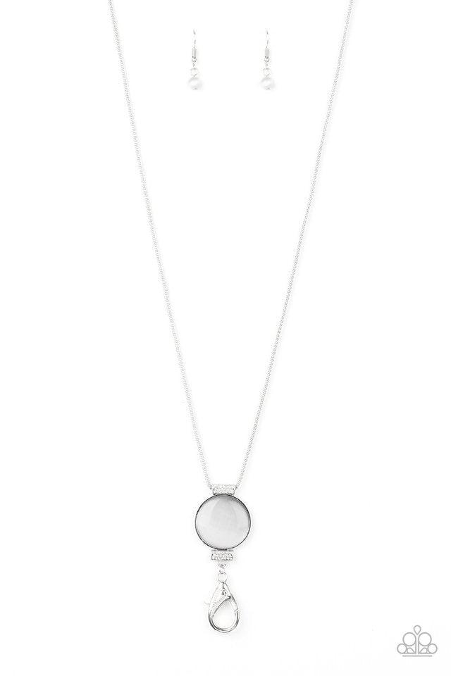 Paparazzi Accessories Happy As Can BEAM - White *Lanyard Infused with white rhinestone encrusted fittings, a glowing white moonstone pendant swings from the bottom of a rounded silver mesh chain for a whimsical look. A lobster clasp hangs from the bottom