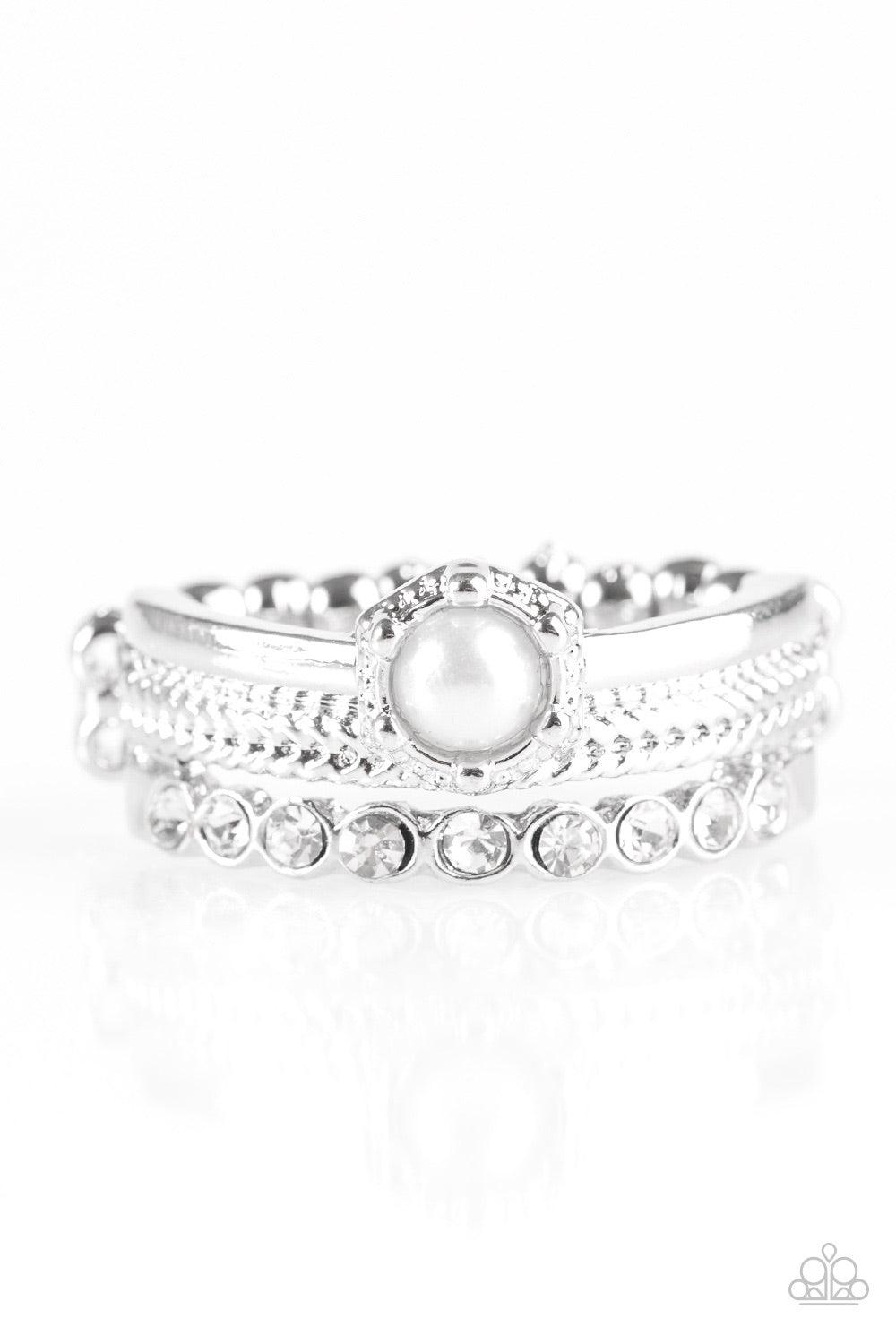 Paparazzi Accessories STAR Raving Mad - White Featuring smooth, dotted, and rhinestone encrusted surfaces, glistening silver bands layer across the finger creating mismatched shimmer. A classic white pearl adorns the layers, creating a timeless centerpiec