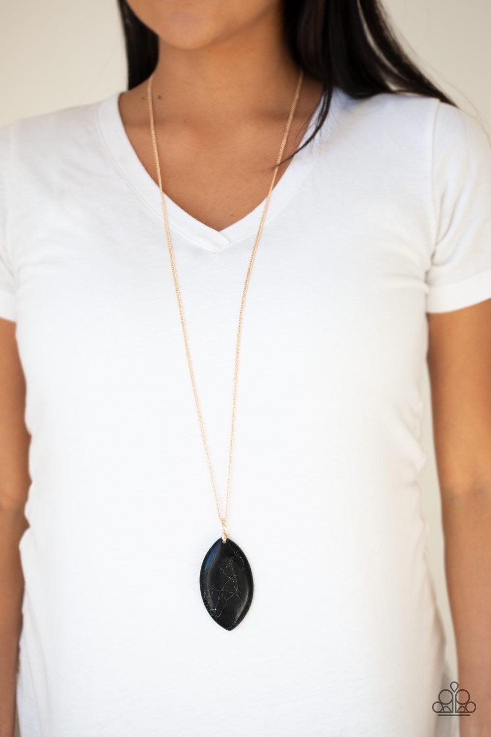 Paparazzi Accessories Santa Fe Simplicity - Black Chiseled into a tranquil almond-shape, an oversized black stone pendant swings from the bottom of a lengthened gold chain in a seasonal fashion. Features an adjustable clasp closure. Jewelry