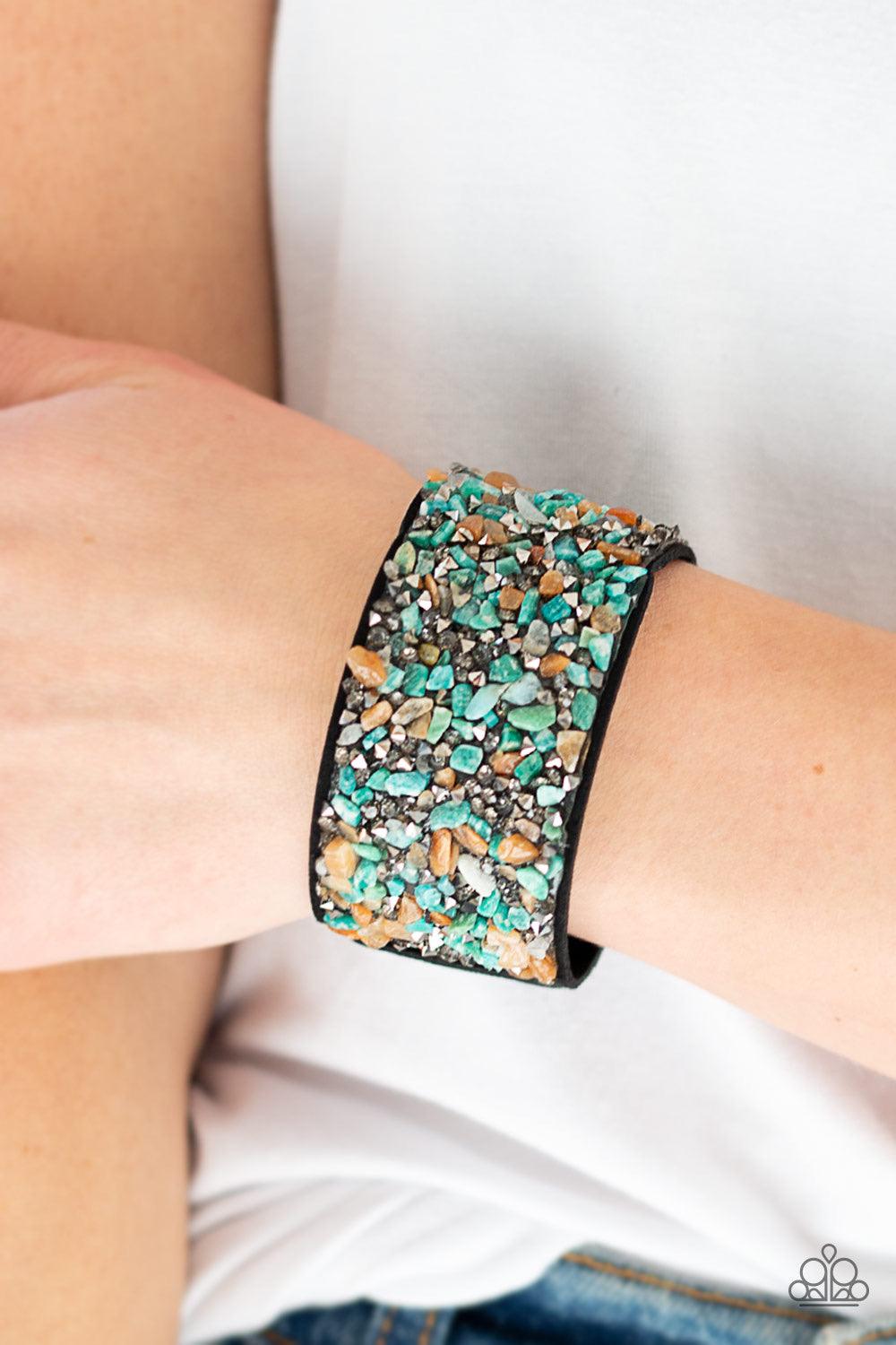 Paparazzi Accessories Crush Rush ~Multi Smoky and hematite prism style rhinestones and bits of crushed multicolored rock are sprinkled across a thick black suede band for an edgy look. Features an adjustable snap closure. Sold as one individual bracelet.