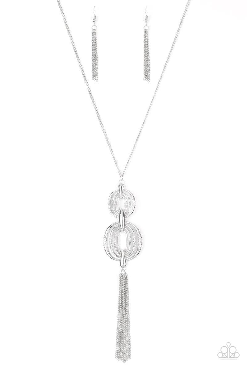 Paparazzi Accessories Timelessly Tasseled - Silver Delicately hammered in sections of shimmer, silver circular frames stack into a bold pendant at the bottom of a lengthened silver chain. A shimmery silver tassel swings from the bottom of the stacked pend