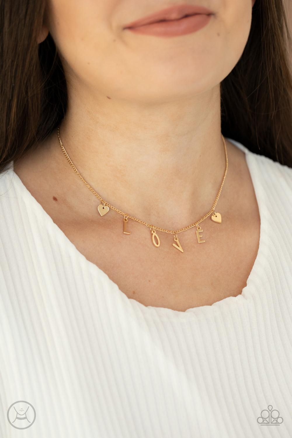 Paparazzi Accessories Love Conquers All - Gold Nestled between a pair of dainty gold hearts, dangling gold letter charms spell out the word, "LOVE," creating a flirty fringe around the neck. Features an adjustable clasp closure. Sold as one individual cho