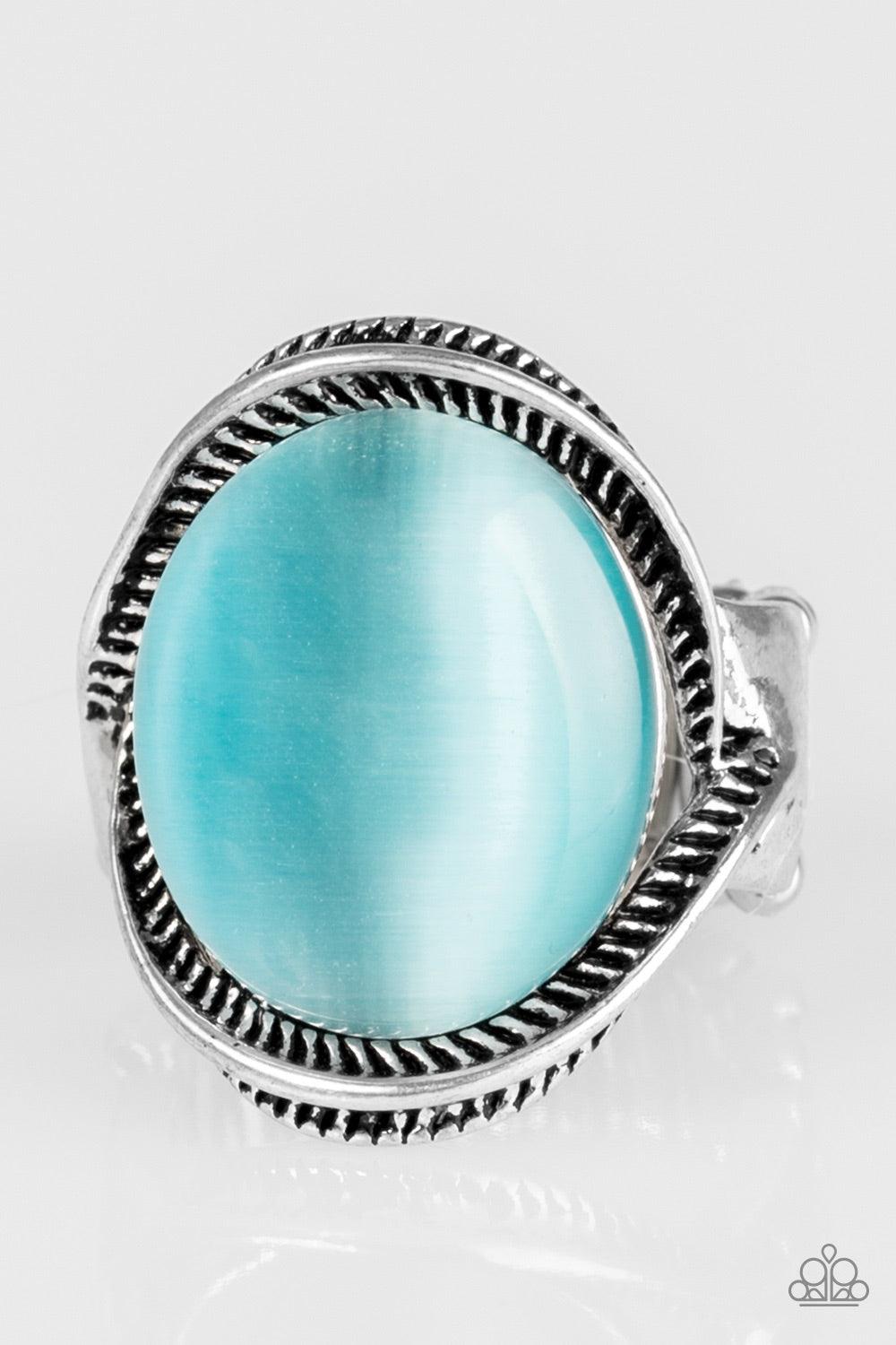Paparazzi Accessories GLOW But Sure - Blue Etched in serrated textures, silver ribbons swoop around a glowing blue moonstone for a whimsical look. Features a stretchy band for a flexible fit. Jewelry