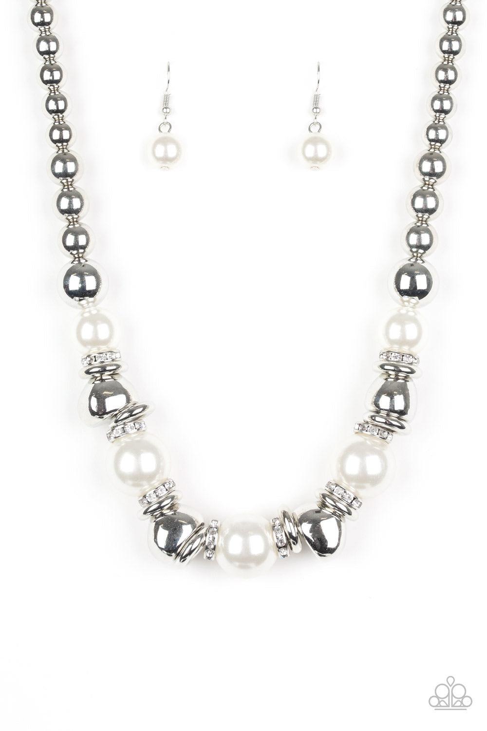 Paparazzi Accessories Hollywood HAUTE Spot - White A collection of oversized white pearls, silver rings, and asymmetrical silver beads are threaded along an invisible wire below the collar. White rhinestone encrusted rings are sprinkled between the refine