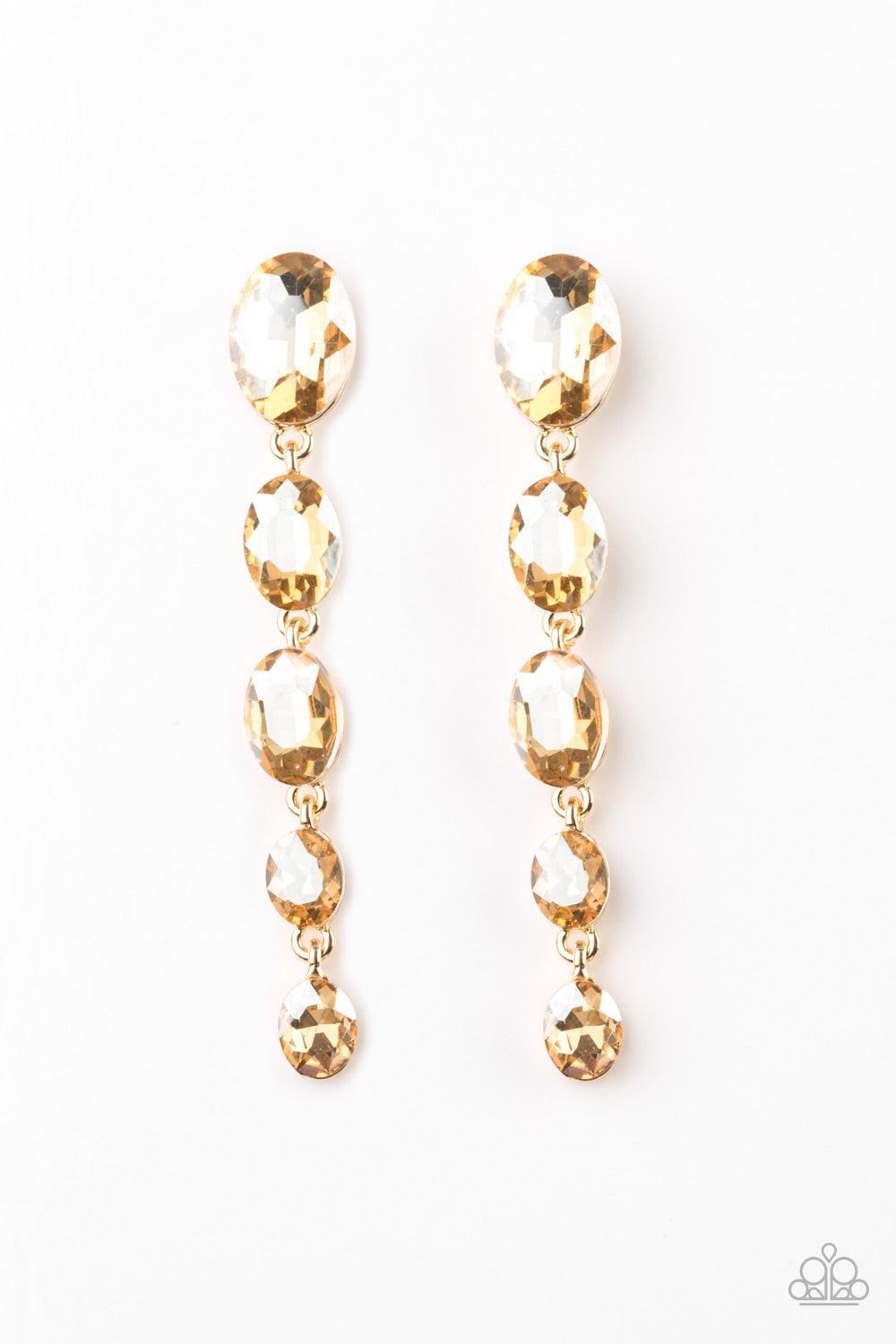Paparazzi Accessories Red Carpet Radiance - Gold Gradually decreasing in size, golden gems trickle from the ear in a glamorous fashion. Earring attaches to a standard post fitting. Jewelry