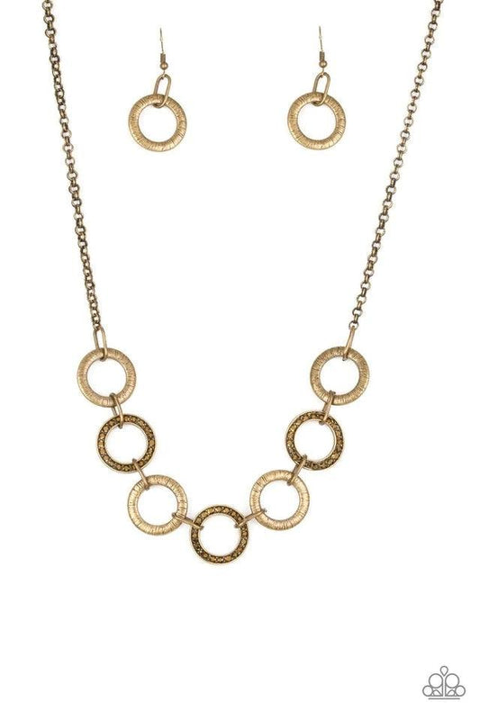 Paparazzi Accessories Modern Day Madonna - Brass Textured brass hoops and glittery hematite rhinestone encrusted hoops link below the collar for a sassy industrial look. Features an adjustable clasp closure. Sold as one individual necklace. Includes one p
