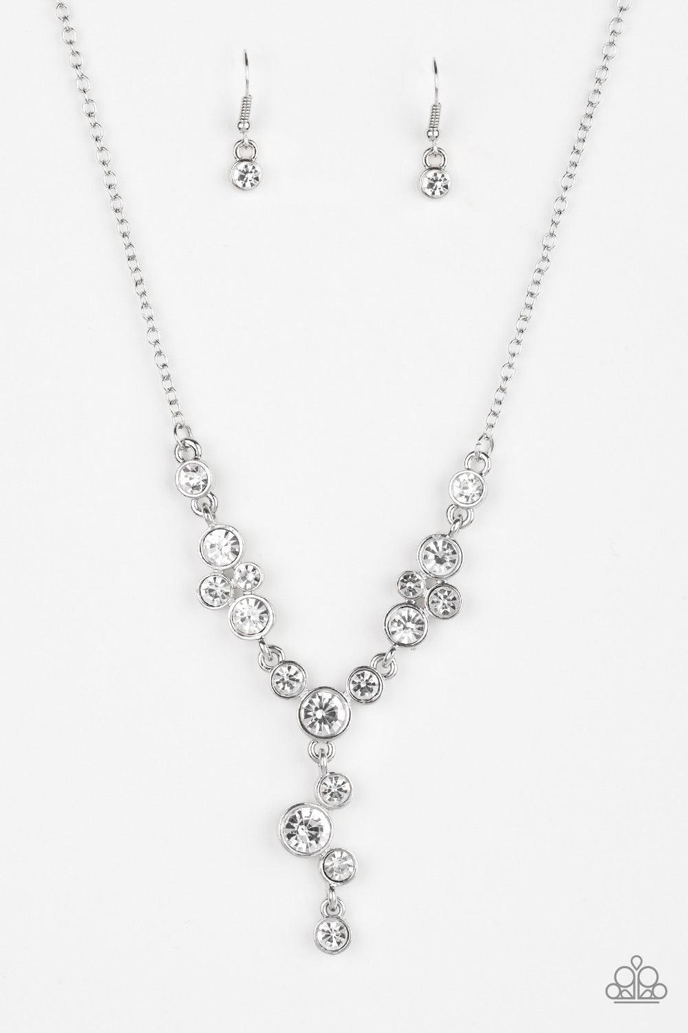 Paparazzi Accessories Five-Star Starlet - White Encased in sleek silver frames, a collection of glittery white rhinestones coalesce into dazzling frames below the collar. Matching rhinestones trickle from the center, creating a glamorous extended pendant.