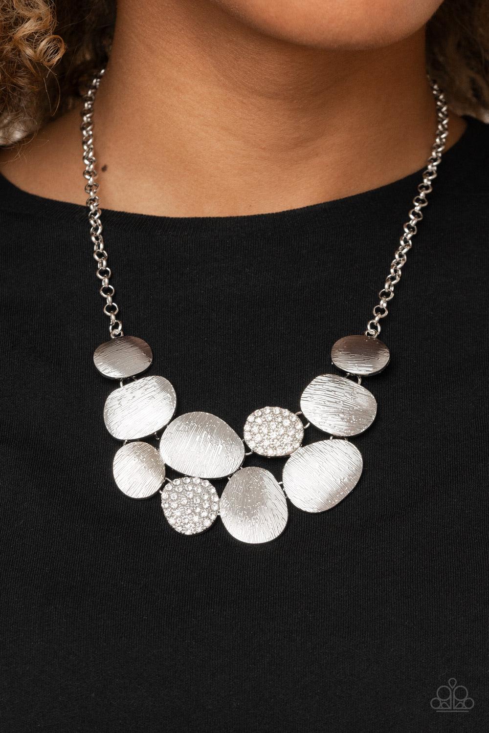 Paparazzi Accessories A Hard LUXE Story - White Featuring imperfect oval shapes, a series of delicately scratched and white rhinestone encrusted frames connect into a clustered pendant below the collar for a refined flair. Features an adjustable clasp clo