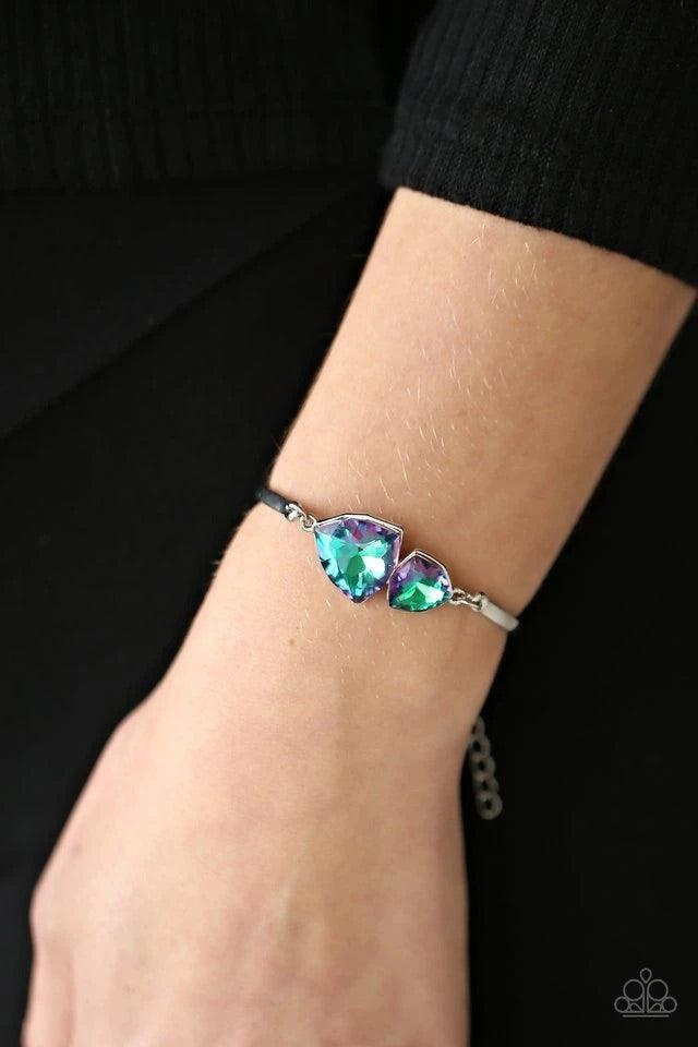 Paparazzi Accessories Deep Space Shimmer - Purple Featuring raw gem cuts, a pair of iridescent rhinestones connect to dainty silver bars around the wrist, creating a stellar cuff-like bracelet. Features an adjustable clasp closure. A Beautiful pair of sto