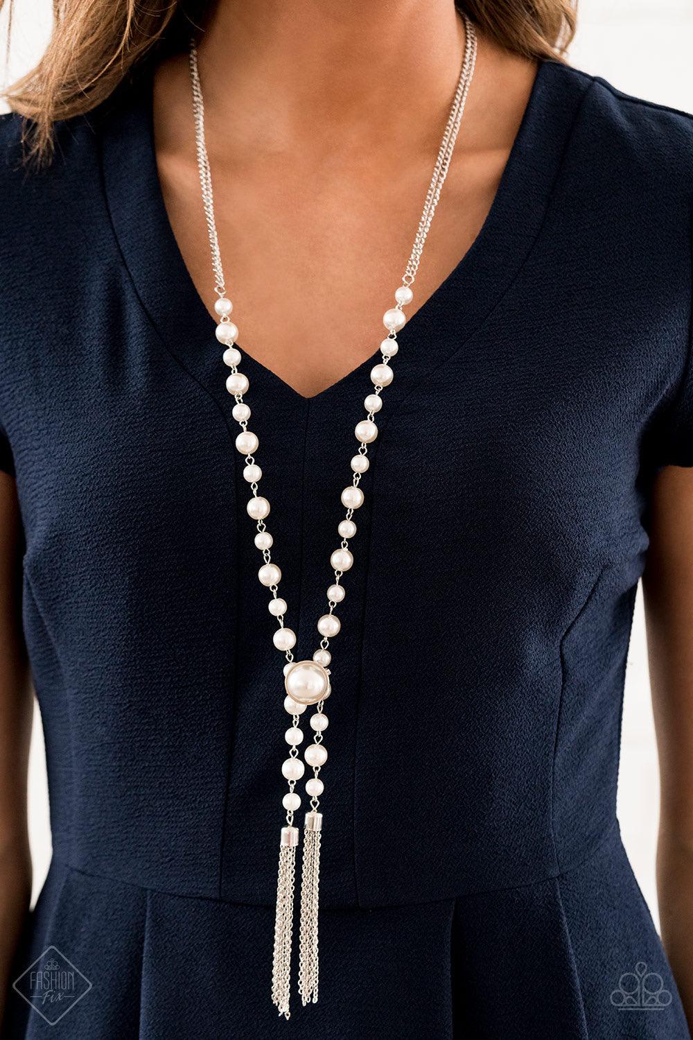 Paparazzi Accessories Vintage Diva ~White An open-ended strand of silver chain is dotted with elegant white pearls and finished off with two streaming silver tassels. An oversized pearl attached to a standard pin closure creates an adjustable fitting that