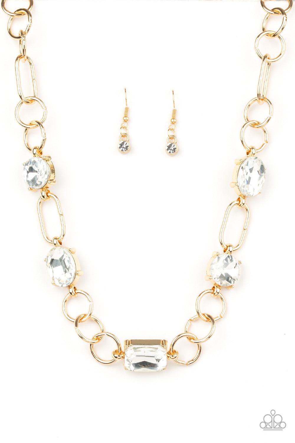 Paparazzi Accessories Urban District ~Gold Featuring round, oval, and emerald style cuts, glittery white rhinestone fittings link with mismatched gold rings below the collar for an edgy glamorous look. Features an adjustable clasp closure.
