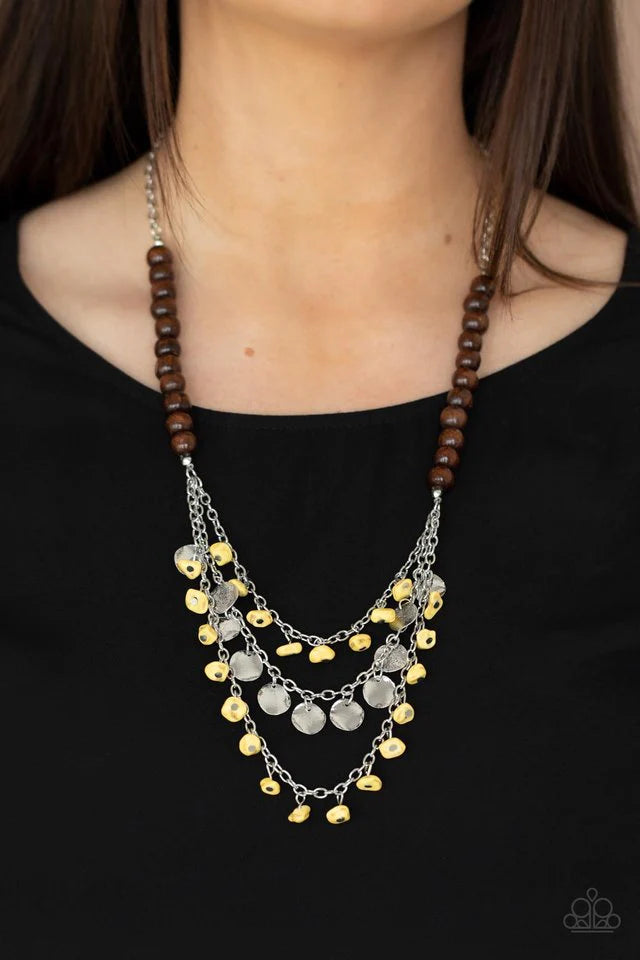 Paparazzi Accessories Plains Paradise - Yellow Adorned with yellow pebbles and hammered silver discs, three silver chains layer from strands of brown wooden beads, creating an earthy fringe below the collar. Features an adjustable clasp closure. Sold as o