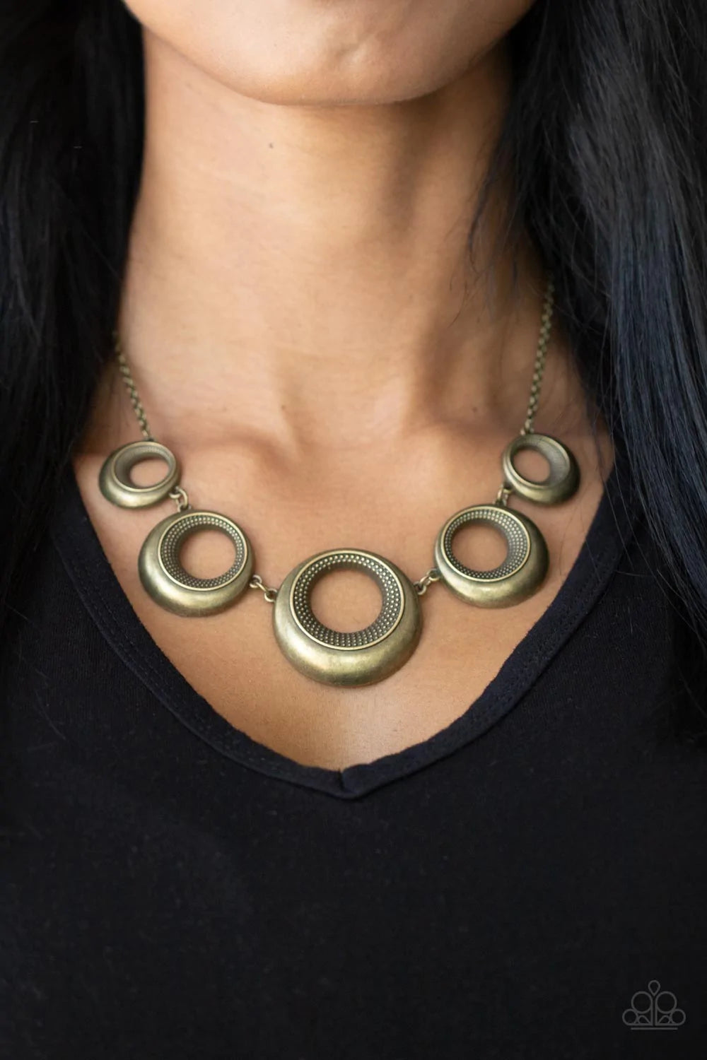 Paparazzi Accessories Solar Cycle - Brass Featuring studded centers, an antiqued collection of beveled brass hoops gradually increase in size as they link below the collar for a bold metallic look. Features an adjustable clasp closure. Sold as one individ