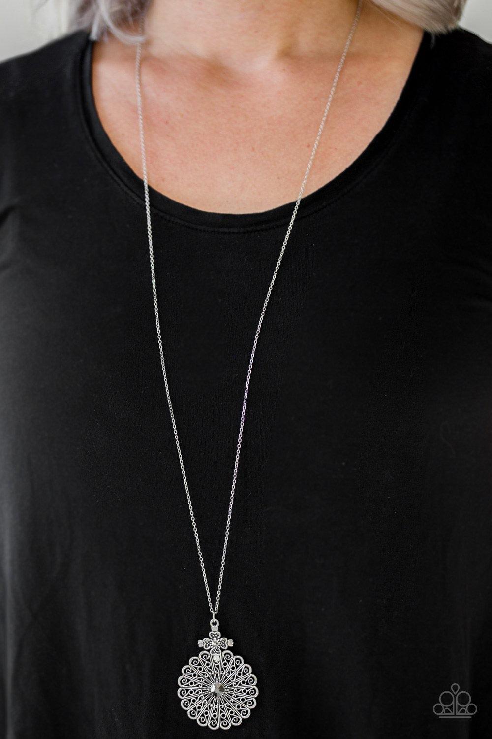 Paparazzi Accessories Walk on The WILDFLOWER Side - Silver Filigree filled petals flare from a glittery hematite rhinestone center, creating a whimsical floral pendant at the bottom of a lengthened silver chain. Features an adjustable clasp closure. Jewel