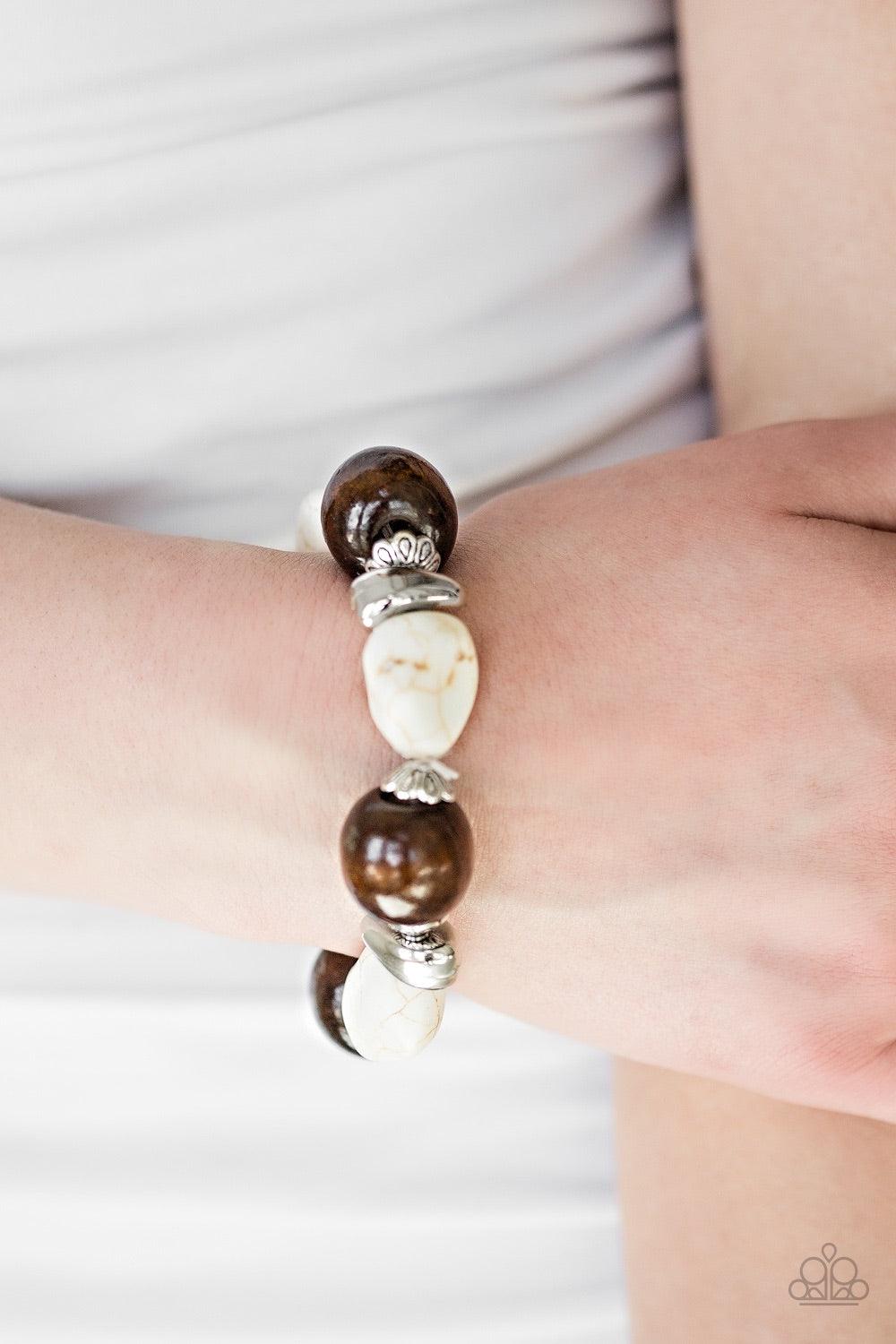 Paparazzi Accessories Gorgeously Grounded - White Infused with ornate silver accents, refreshing white stones and earthy wooden beads are threaded along a stretchy elastic band for a seasonal look. Jewelry