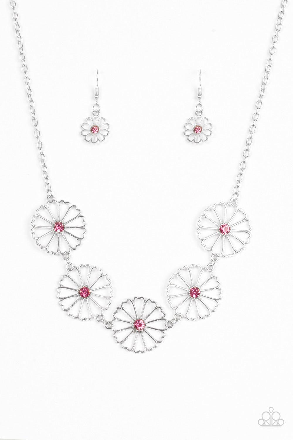 Paparazzi Accessories Daffodil Gardens - Pink Stenciled silver floral charms link below the collar. Glittery pink rhinestones dot the floral centers, adding a whimsical finish to the airy palette. Features an adjustable clasp closure. Sold as one individu