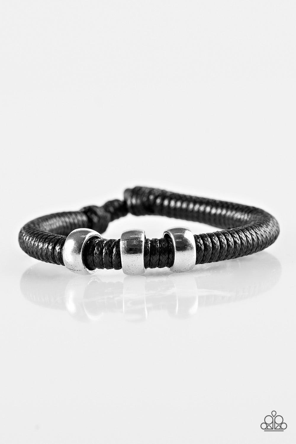 Paparazzi Accessories One For The Trail - Black Shiny black twine wraps around a black cord, creating an urban look around the wrist. Shiny silver beads slide along the cording for a rugged finish. Features an adjustable sliding knot closure. Jewelry