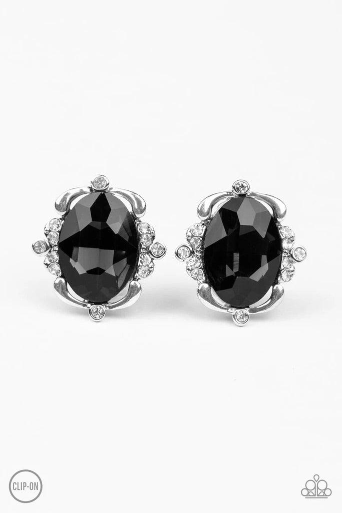 Paparazzi Accessories Regally Radiant ~Black *Clip-On Sporadically dotted in sections of glassy white rhinestones, shimmery ribbons of silver gently fold around a dazzling black emerald-style gem center for a regal look. Earring attaches to a standard cli