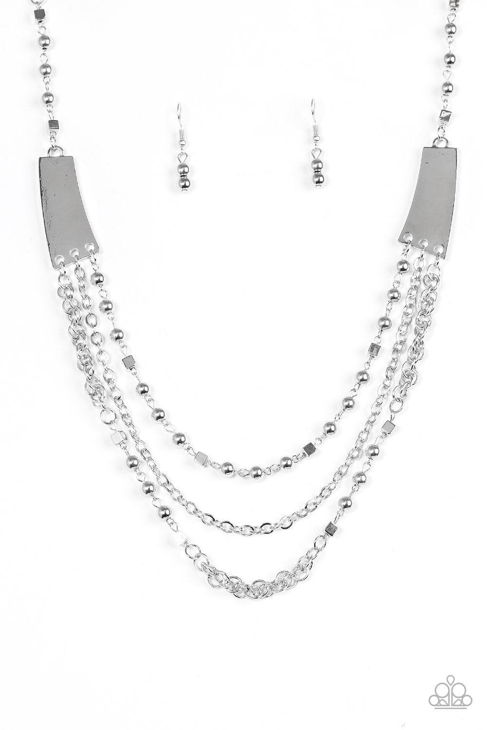 Paparazzi Accessories Marvelously Metro - Silver Varying in shape and shimmer, three glistening silver chains stream from the bottom of two silver plates. Infused with round and square silver accents, the mishmash of chains layer down the chest in a bold