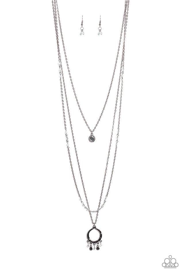 Paparazzi Accessories Treasures And Trinkets ~Black nfused with sporadic sections of dainty crystal-like beads, three dainty gunmetal chains layer down the chest. A dainty gunmetal frame swings from the uppermost chain, while a hammered pendant featuring