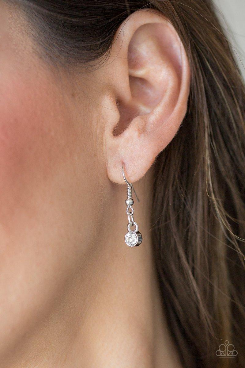 Paparazzi Accessories The Imperfectionist - Silver Featuring shimmery silver frames, imperfect white gems link below the collar for a glamorous vintage inspired look. Features an adjustable clasp closure. Sold as one individual necklace. Includes one pair