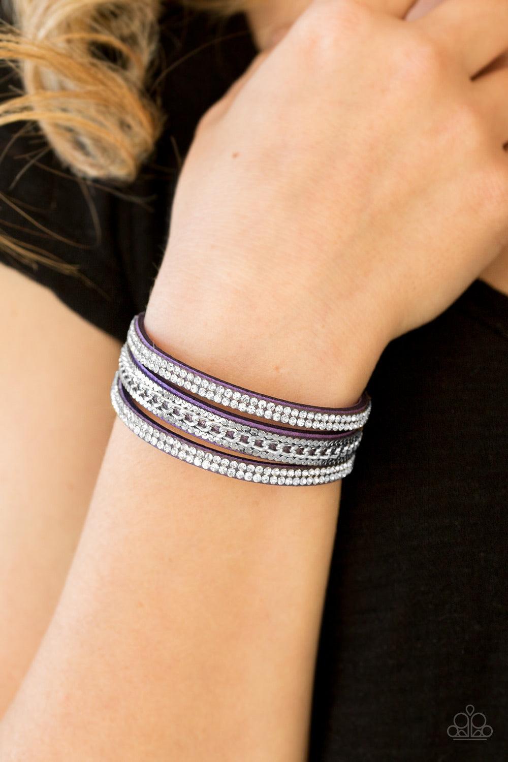 Paparazzi Accessories Unstoppable ~Purple Glassy white rhinestones and shimmery silver chains are encrusted along strands of purple suede, creating a mishmash of sassy shimmer around the wrist for a fierce look. Features an adjustable snap closure. Sold a