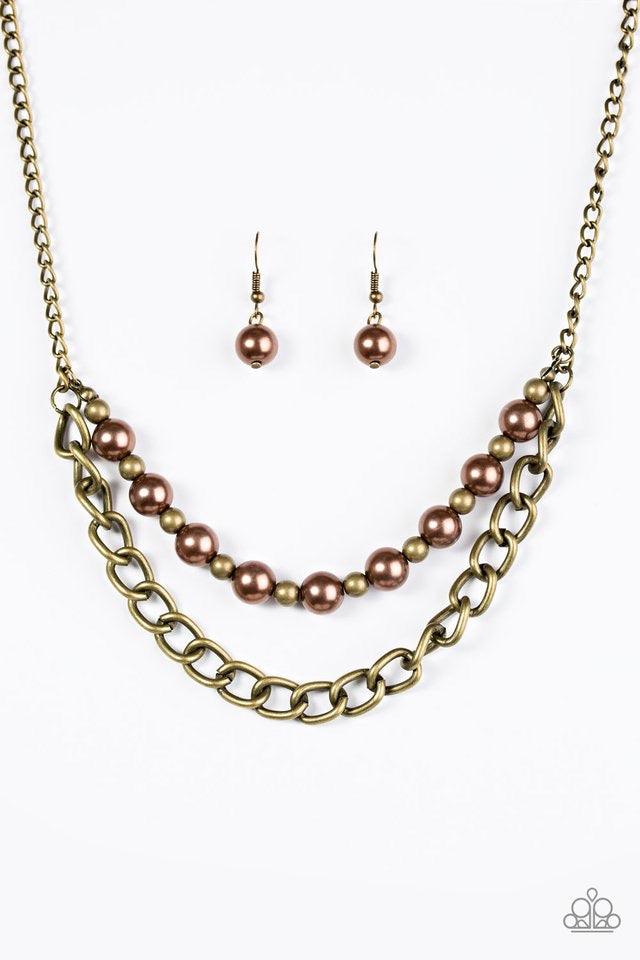 Paparazzi Accessories Glam And Grind - Brass Pearly brown and rustic brass beads are threaded along a skinny wire. The pearly beading gives way to a bold strand of brass chain, creating edgy layers below the collar. Features an adjustable clasp closure. S