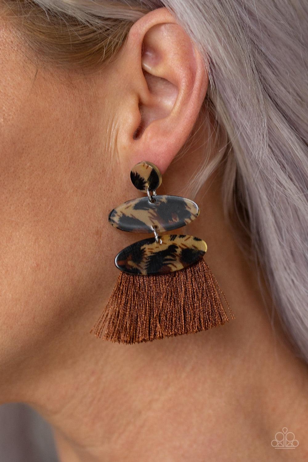 Paparazzi Accessories No One Likes A Cheetah - Brown Featuring cheetah-like print, glassy frames link into a stacked lure. A fringe of shiny brown thread streams from the bottom of the lure for a retro finish. Earring attaches to a standard post fitting.
