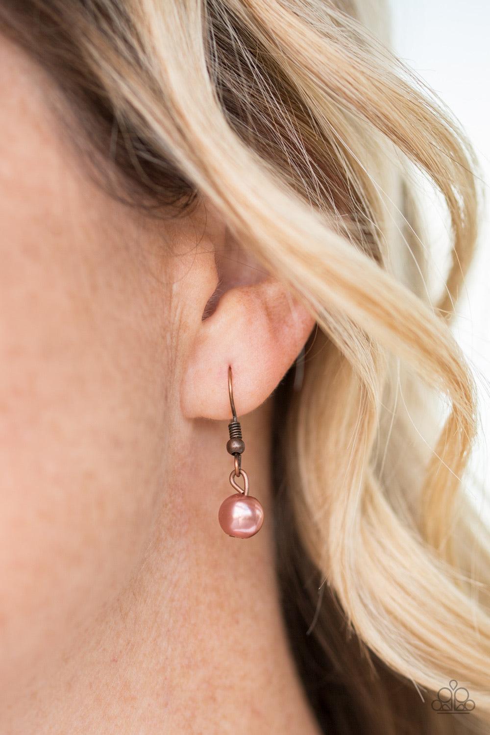 Paparazzi Accessories Shipwreck Style - Copper Brushed in an antiqued shimmer, mismatched copper hoops, copper pearls, and dainty copper beads swing from the bottom of a bold copper chain below the collar for a refined look. Features an adjustable clasp c