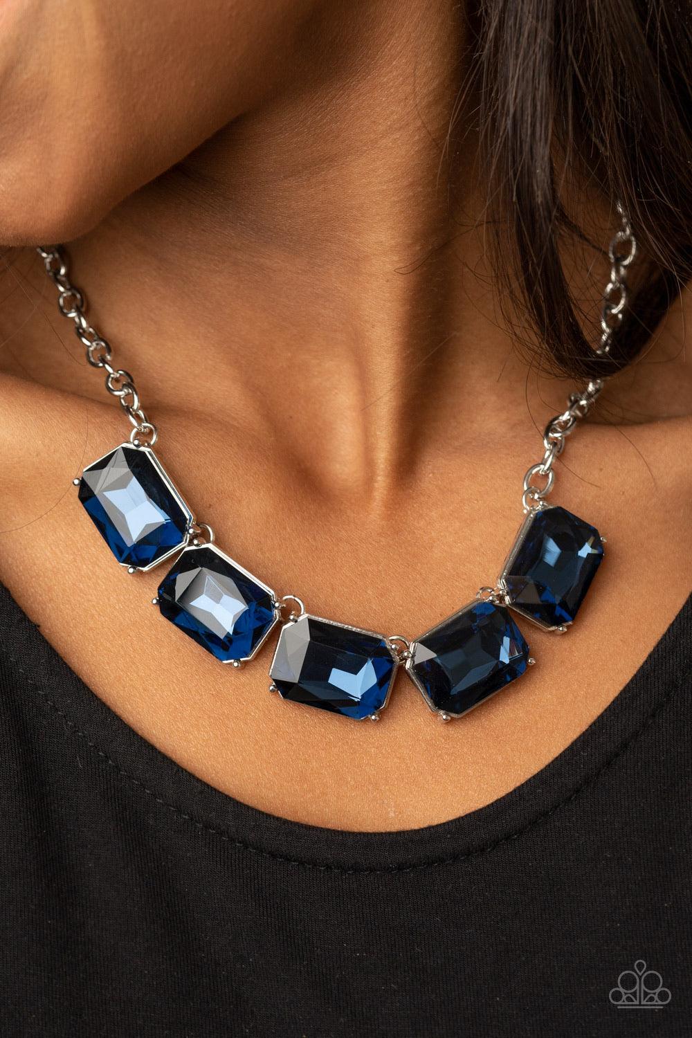 Paparazzi Accessories Deep Freeze Diva - Blue Featuring regal emerald style cuts, an oversized collection of blue rhinestones dramatically link below the collar for an icy finish. Features an adjustable clasp closure. Sold as one individual necklace. Incl