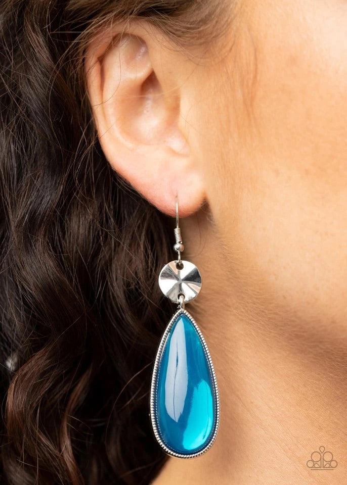 Paparazzi Accessories Jaw-Dropping Drama - Blue A creased silver disc gives way to a dramatically oversized glassy blue teardrop frame, creating a colorful statement. Earring attaches to a standard fishhook fitting. Sold as one pair of earrings. Jewelry