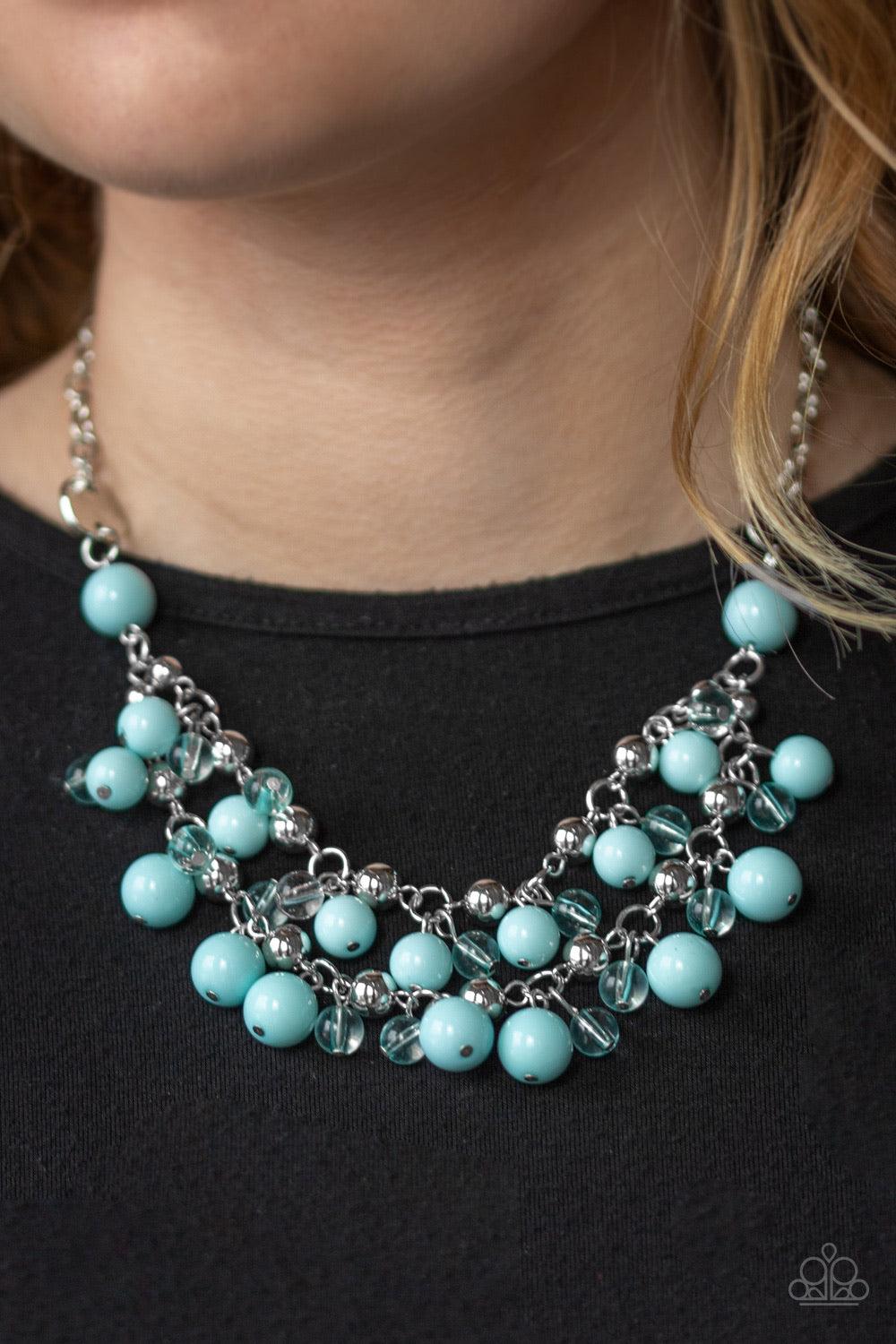 Paparazzi Accessories Seaside Soirée - Blue Hammered silver discs give way to layers of polished blue, glassy, and shiny silver beads. The colorful collection layers below the collar, creating a bubbly fringe. Features an adjustable clasp closure. Sold as