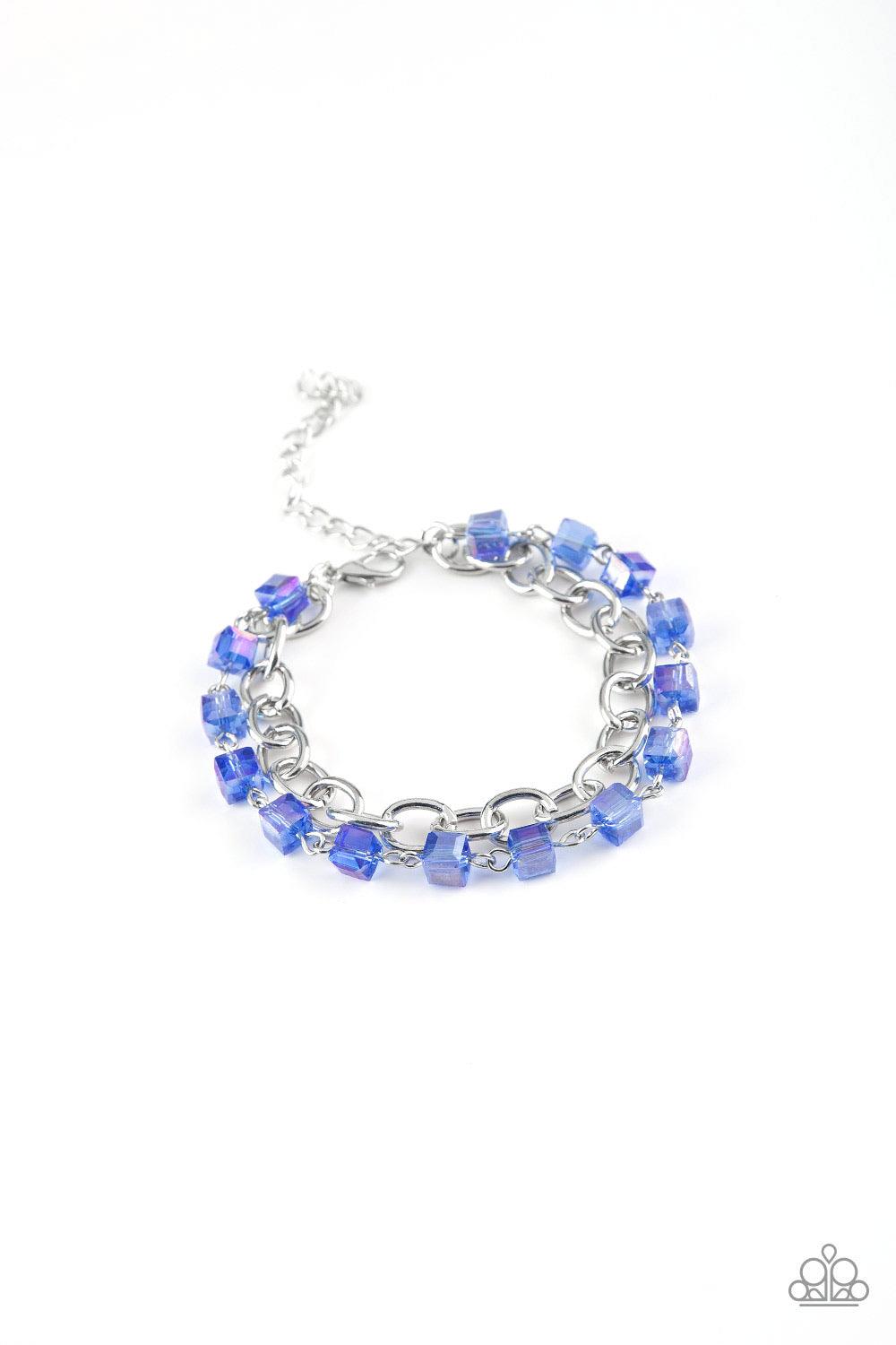 Paparazzi Accessories Life Of The Block Party - Blue A strand of iridescent blue crystal-like cube beading joins a classic strand of silver chain around the wrist, creating refined layers. Features an adjustable clasp closure. Sold as one individual brace