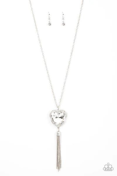 Paparazzi Accessories Finding My Forever - White Bordered in a ribbon of glassy white rhinestones, an oversized white heart-shaped gem seemingly floats at the bottom of an extended silver chain. A shimmery silver chain tassel dances from the bottom of the