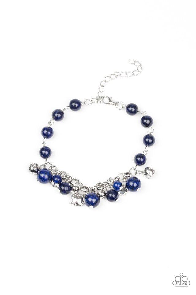 Paparazzi Accessories Glossy Glow - Blue An array of mismatched silver charms and beads swings from a glassy blue beaded bracelet around the wrist, creating a whimsical fringe. Features an adjustable clasp closure. Jewelry