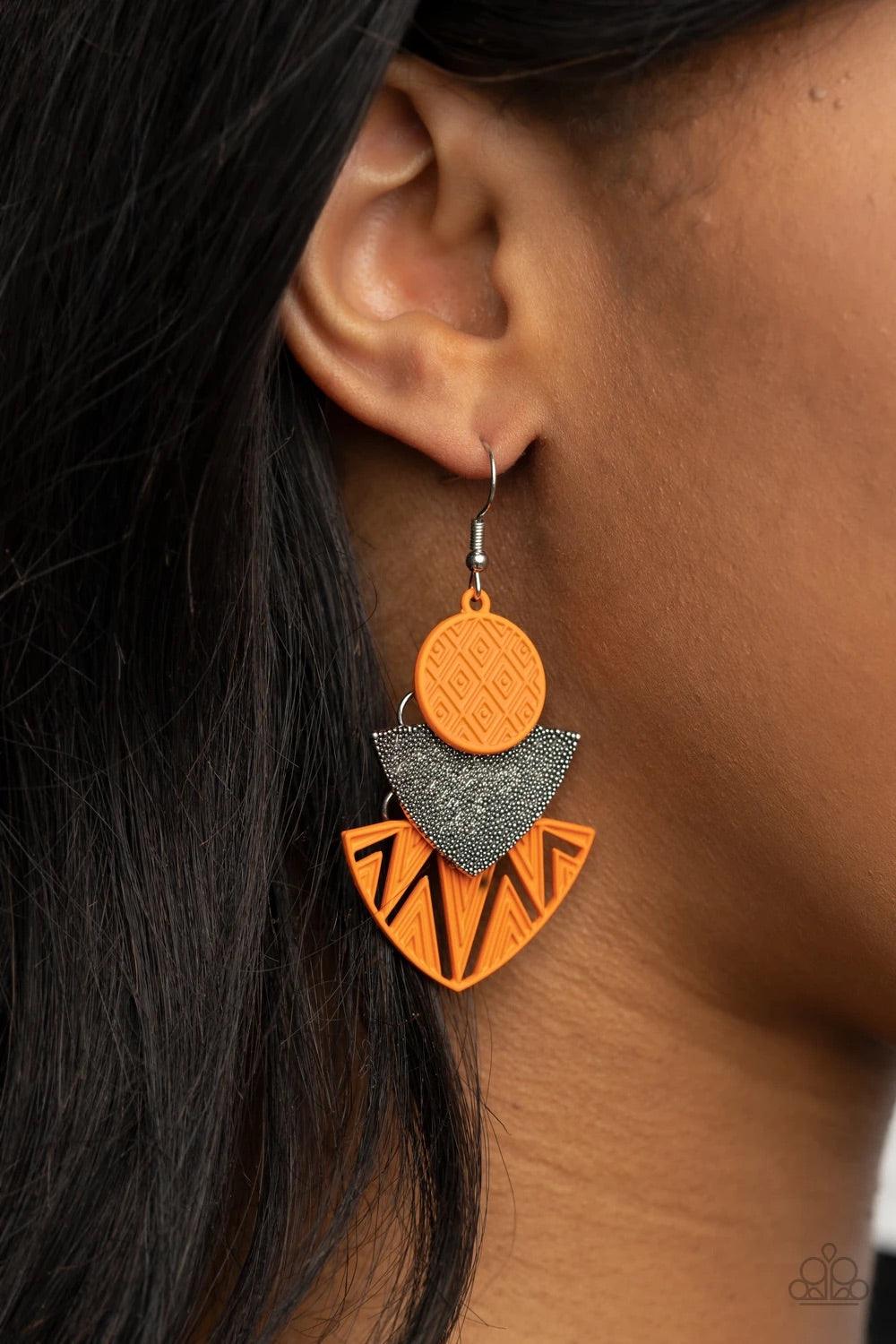 Paparazzi Accessories Jurassic Juxtaposition - Orange Painted in an orange matte, textured frames flank a studded silver frame, connecting into a colorful tribal inspired lure. Earring attaches to a standard fishhook fitting. Sold as one pair of earrings.