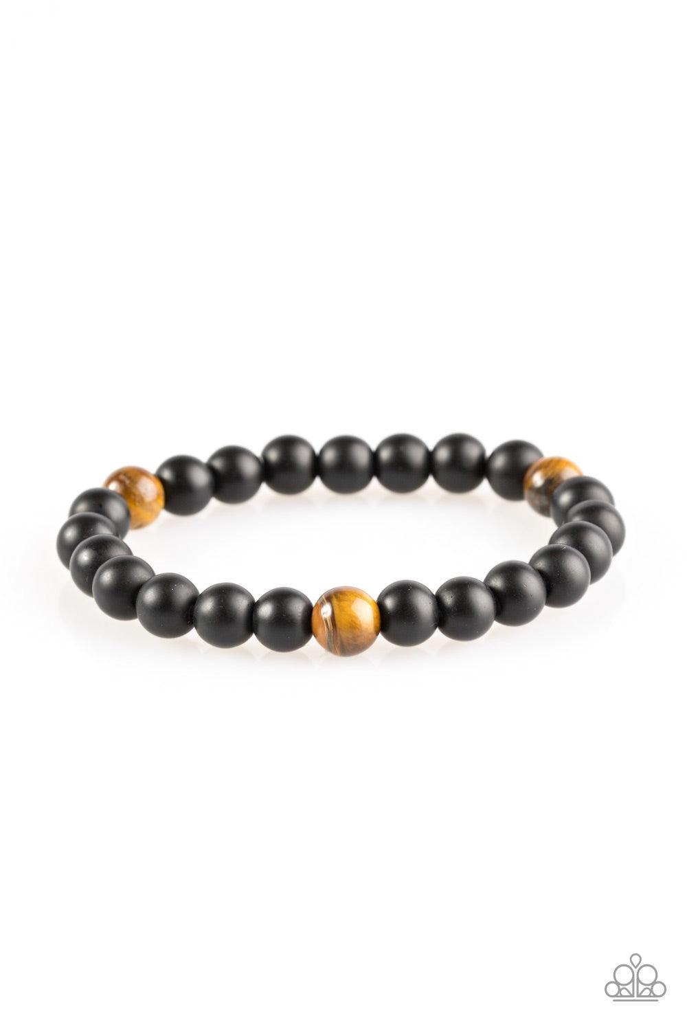 Paparazzi Accessories Harmony - Brown Brushed in a matte finish, glassy black beads are threaded along a stretchy elastic band for a seasonal look. Three Tiger's Eye stones are sprinkled between the beads for an earthy look. Jewelry