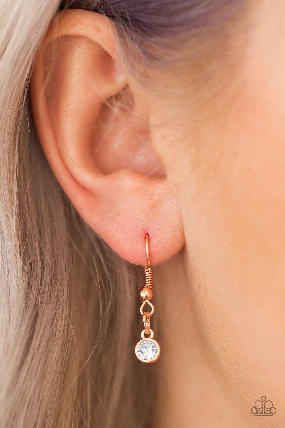 Paparazzi Accessories Million Dollar Drop - Copper A white teardrop gem is pressed into a sleek copper frame, creating a bold 3-dimensional pendant below the collar. Features an adjustable clasp closure. Sold as one individual necklace. Includes one pair