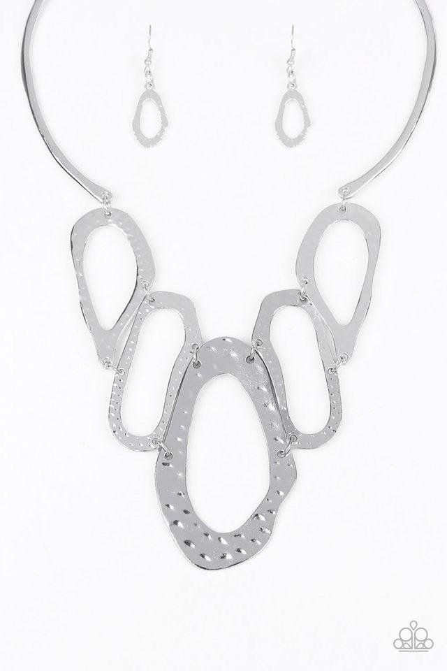 Paparazzi Accessories Prime Prowess - Silver Attached to two bent silver bars, delicately hammered asymmetrical silver hoops link below the collar for an edgy statement making look. Features an adjustable clasp closure. Sold as one individual necklace. In