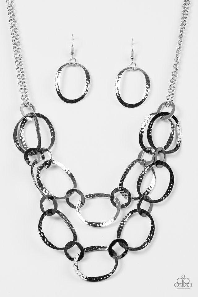 Paparazzi Accessories Circus Chic - Multi Featuring hexagonal centers, one strand of dainty silver and one strand of gunmetal rings link together into two rows of hammered frames. The layered rows drape just below the collar for a refined look. Features a