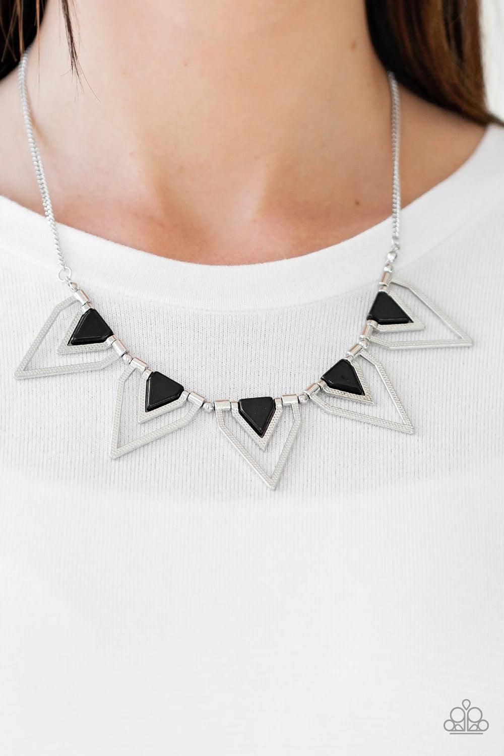 Paparazzi Accessories The Pack Leader - Black Infused with shiny black beading, glistening silver triangular frames join below the collar, creating a fierce geometric fringe. Features an adjustable clasp closure. Sold as one individual necklace. Includes