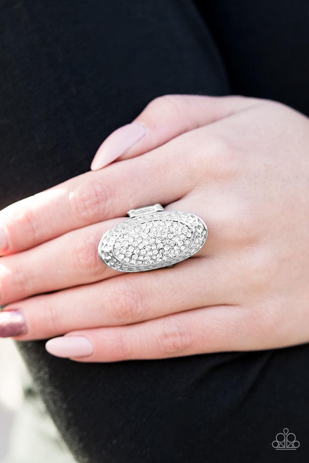Paparazzi Accessories Ka-POW! - Silver Hammered in light catching texture, a sleek oval frame trickles down the finger in an elegant fashion. Encrusted in brilliant white rhinestones, the glitzy centerpiece creates an undeniable statement piece. Features
