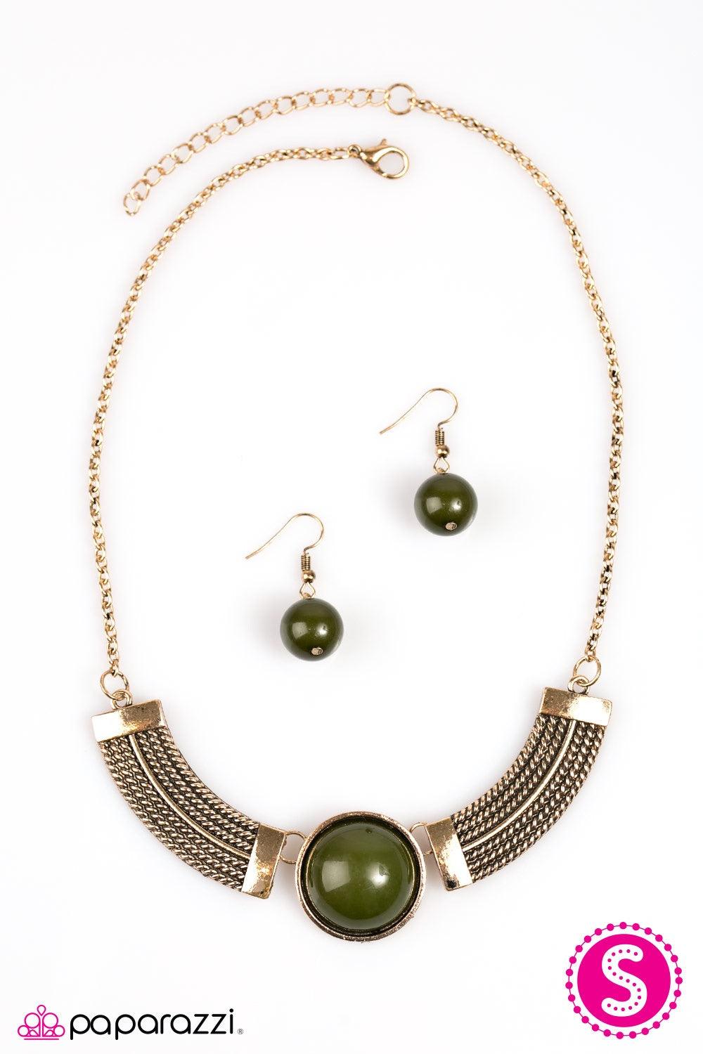 Paparazzi Accessories Egyptian Spell - Green Dramatic gold plates connect with a shiny green circle, creating an indigenous collar-like pendant. Brushed in an antique shimmer, spun ribbons of gold embellish the plates, adding a flashy metallic texture to
