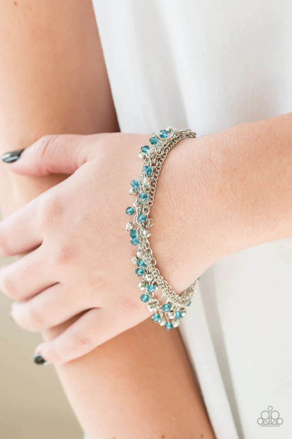 Paparazzi Accessories Cash Confidence - Blue Dainty silver and blue crystal-like beads cascade from two shimmery silver chains. Infused with plain silver chains, the colorful strands layer around the wrist for a flirtatious look. Features an adjustable cl