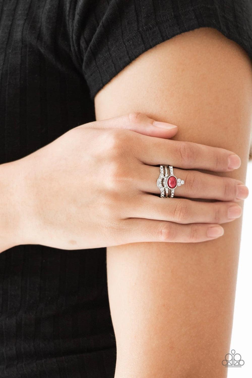 Paparazzi Accessories Timeless Tiaras - Red Encrusted in glassy white rhinestones, dainty silver bars arc across the finger, coalescing into an airy band. Dotted with a pearly red bead, a glittery white rhinestone frame crowns the uppermost band for a reg