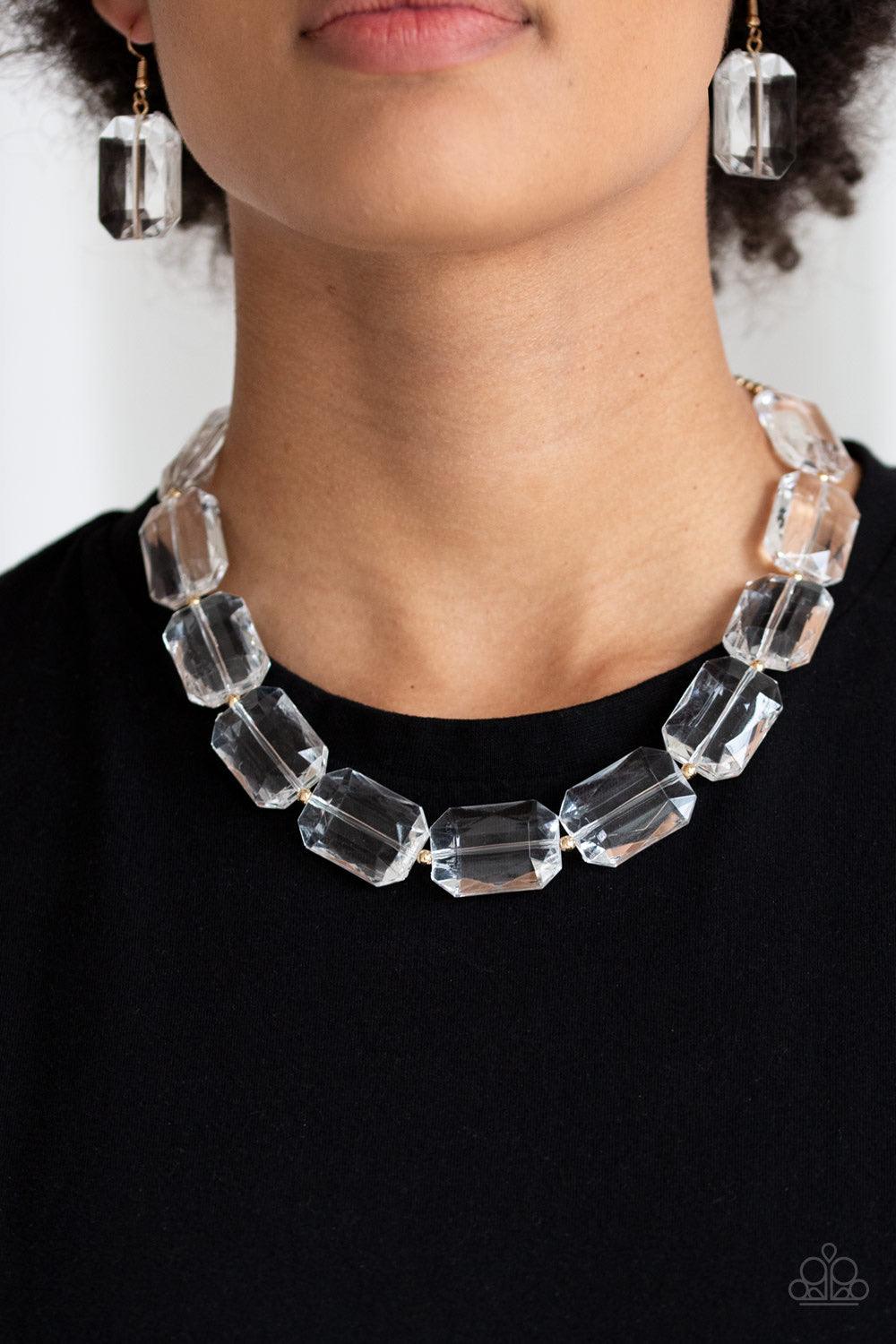 Paparazzi Accessories The ICE President - Gold Infused with dainty gold beads, glassy emerald-cut beads join below the collar for a dramatic look. Features an adjustable clasp closure. Sold as one individual necklace. Includes one pair of matching earring